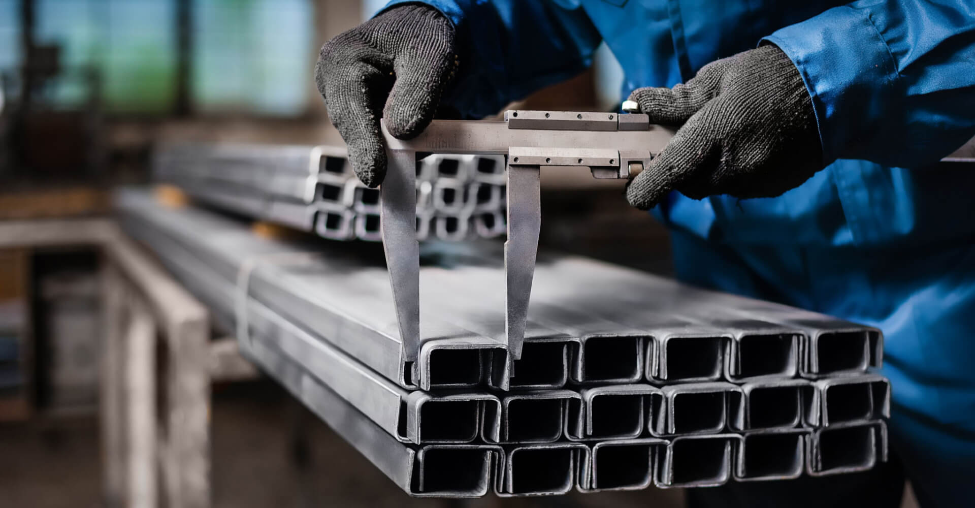 Factory worker measures the metal profile